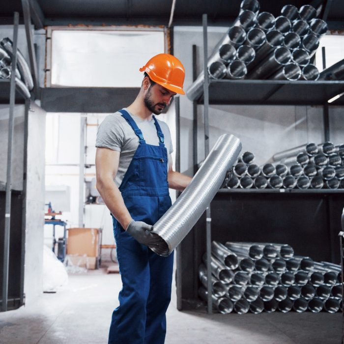 portrait-young-worker-hard-hat-large-metalworking-plant_146671-19572