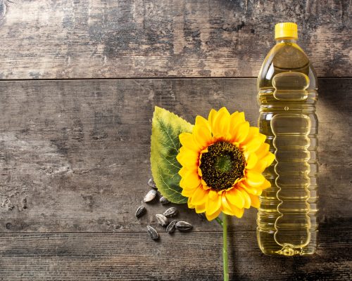 Sunflower oil plastic bottle on wooden table
